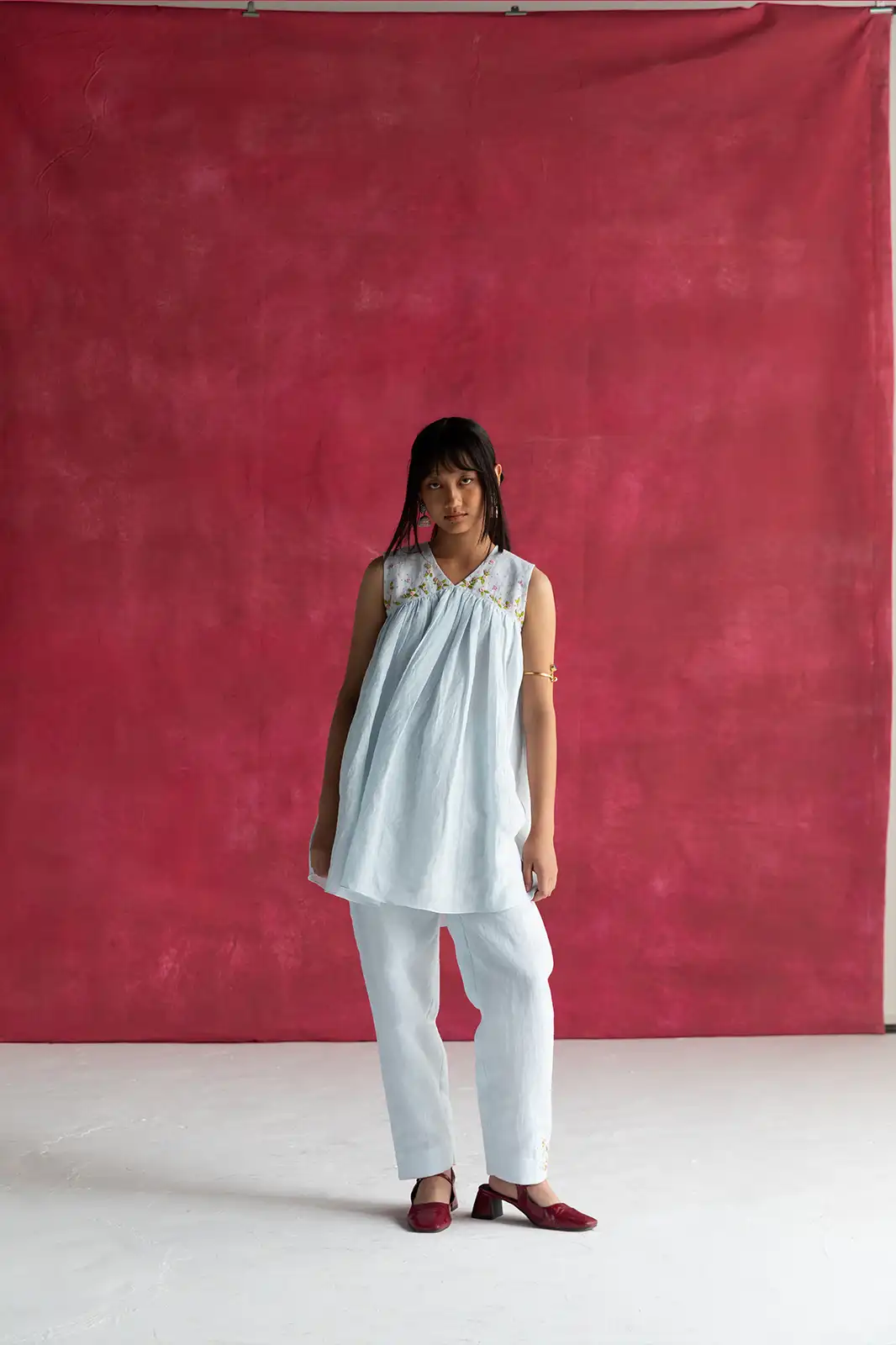 Laugh in Flowers Top, pastel blue linen top, hand embroidered linen top, empire line gathers top, Sepia Stories clothing, pure linen women’s top, sustainable fashion India, designer linen tops, elegant pastel blue blouse, casual linen wear, artisan crafted top