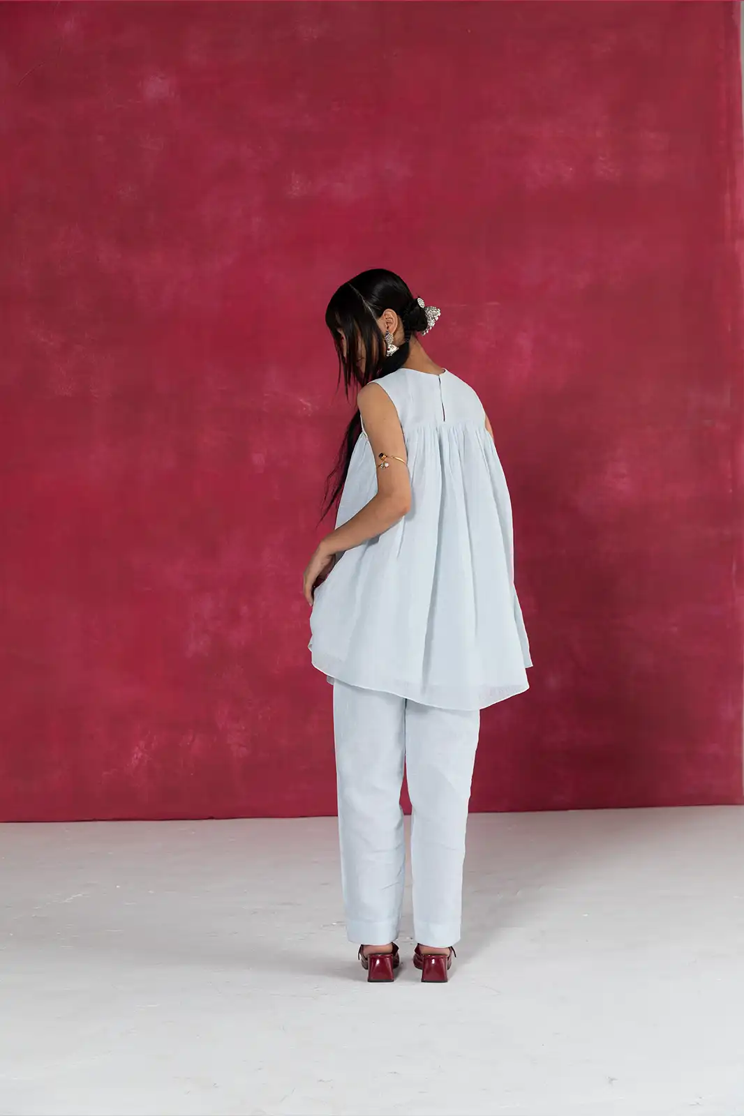 Laugh in Flowers Top, pastel blue linen top, hand embroidered linen top, empire line gathers top, Sepia Stories clothing, pure linen women’s top, sustainable fashion India, designer linen tops, elegant pastel blue blouse, casual linen wear, artisan crafted top