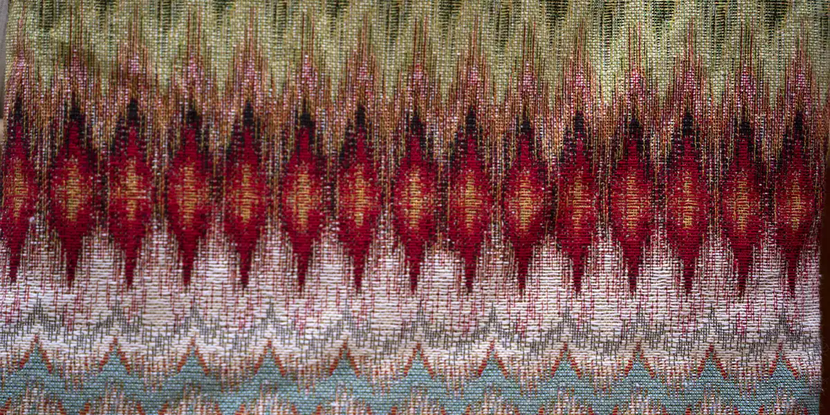 intricate Ikat weaving process, traditional hand-dyed threads colorful red blue yellow patterns, skilled artisan hands loom work dyeing resist tying method, vibrant green purple orange yarns tight knots wooden spool, loom weaving stage adjusting colorful blue green yellow threads wooden frame, pattern alignment check inspecting red yellow blue woven design precision, cultural textile heritage craft illustration, modern traditional technique focus, dynamic color contrast harmony balance, ethnic fabric creation preparation art, detailed thread alignment accuracy concept, contemporary weaving mastery depiction